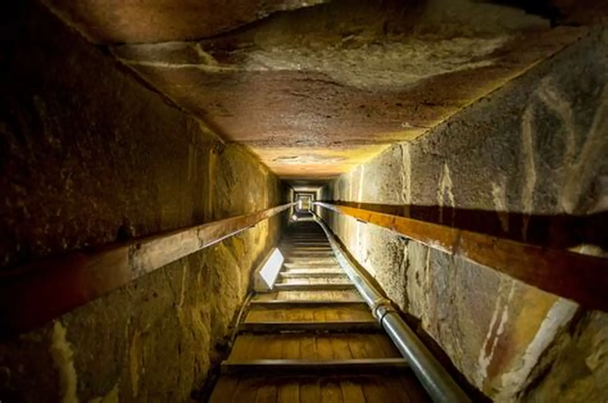 A claustrophobic view of the narrow passage inside the Great Pyramid of Giza.