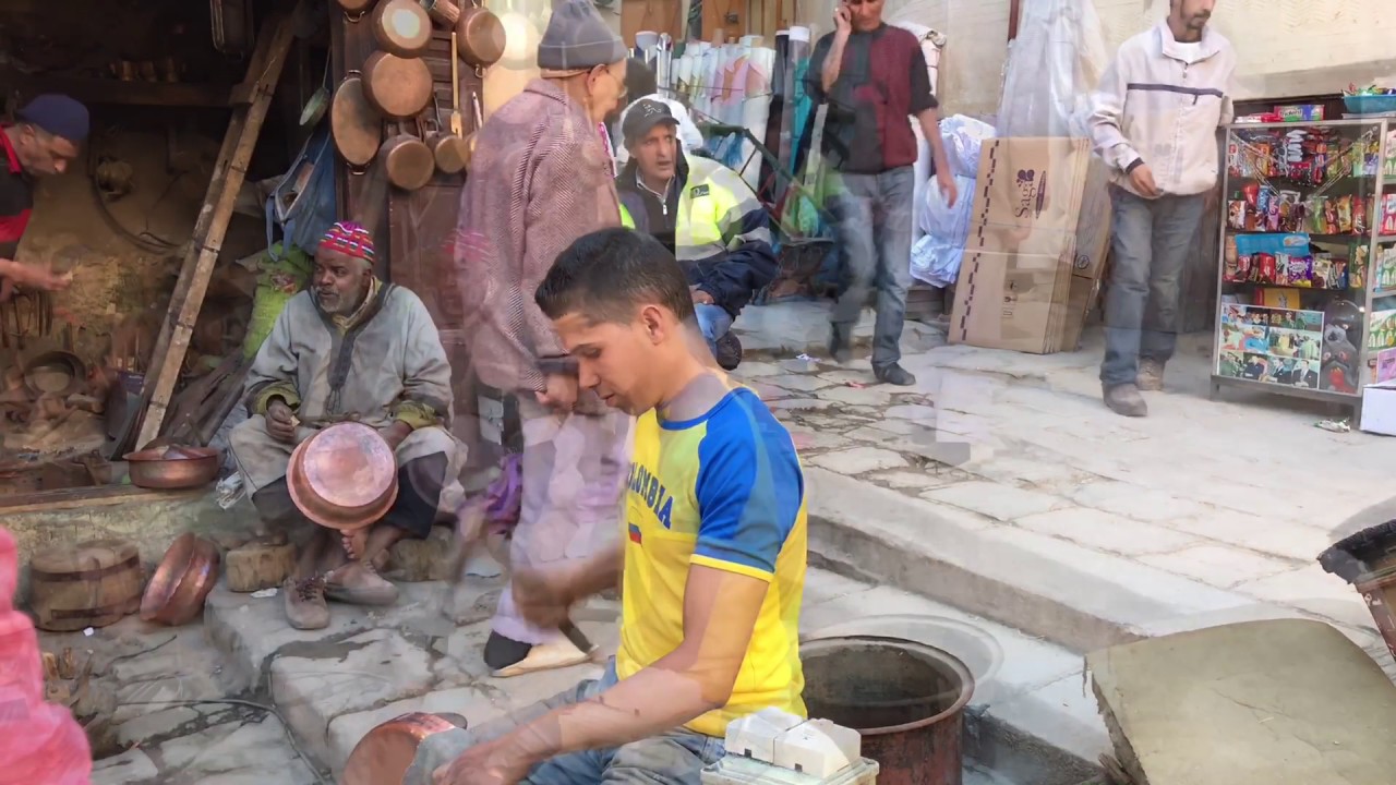 Coppersmiths at work in the bustling Seffarine Square in Fes.