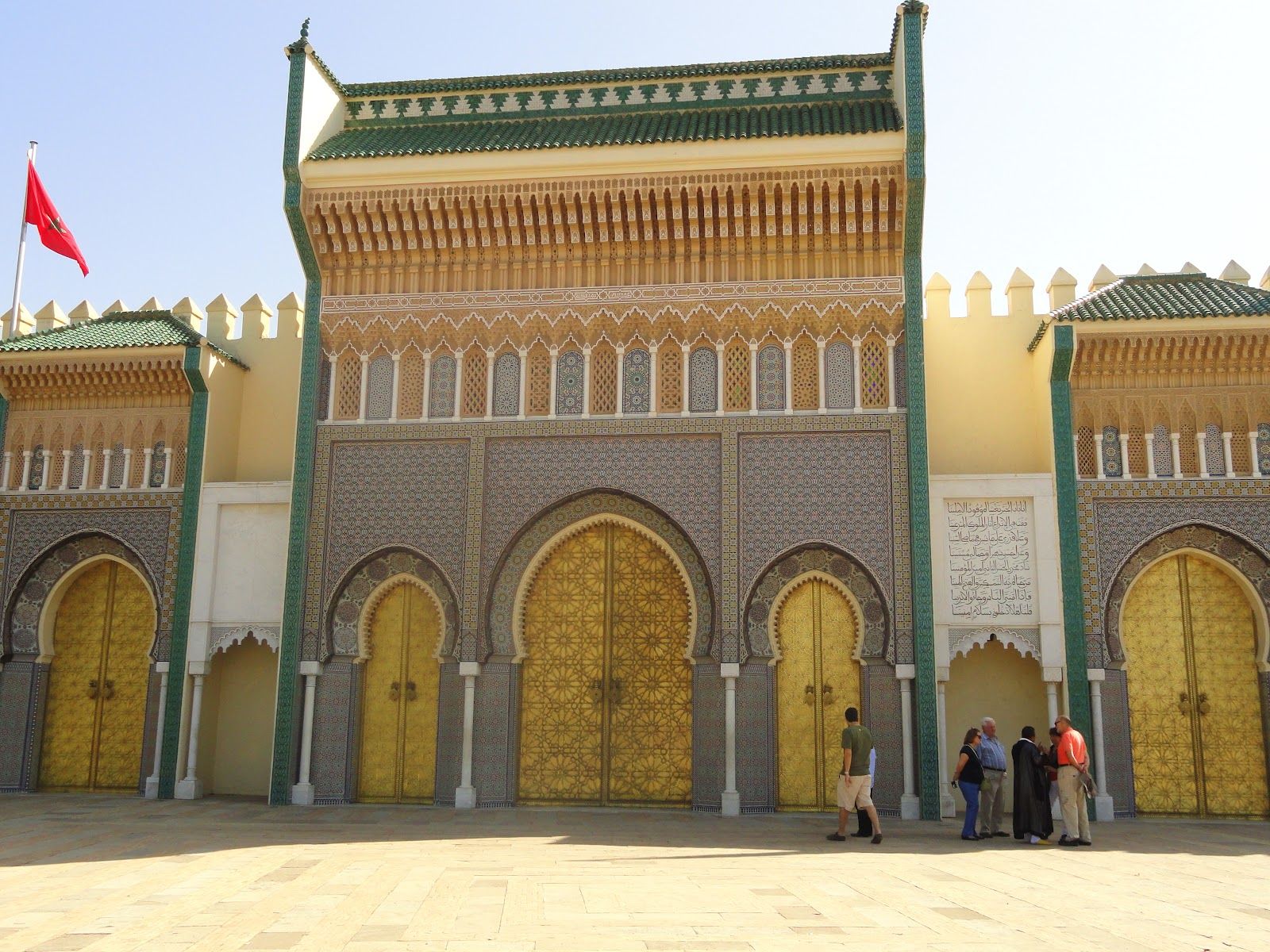 The grand, ornate gates of the Royal Palace of Fes.