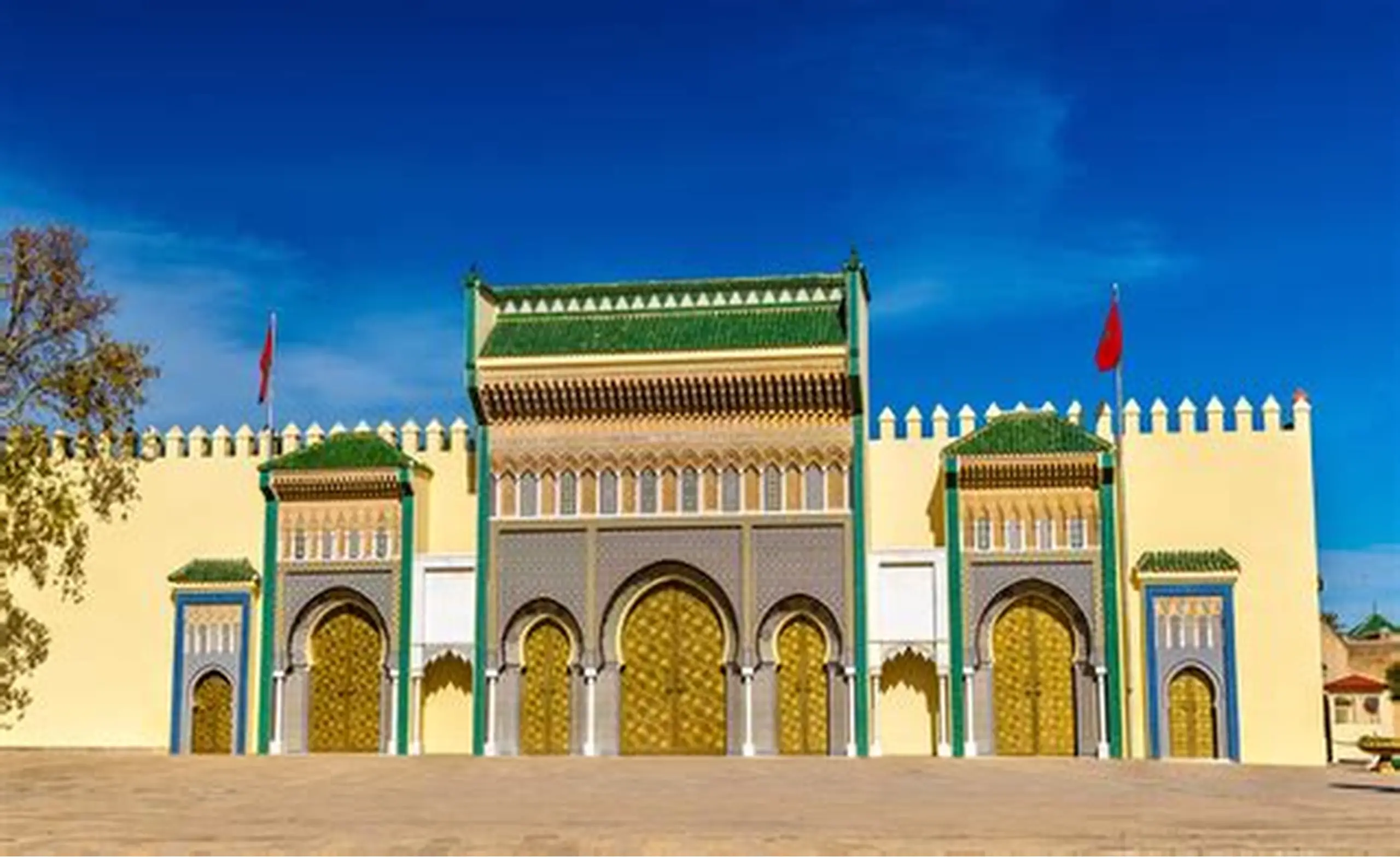 The ornate golden gates of the Royal Palace of Fes.