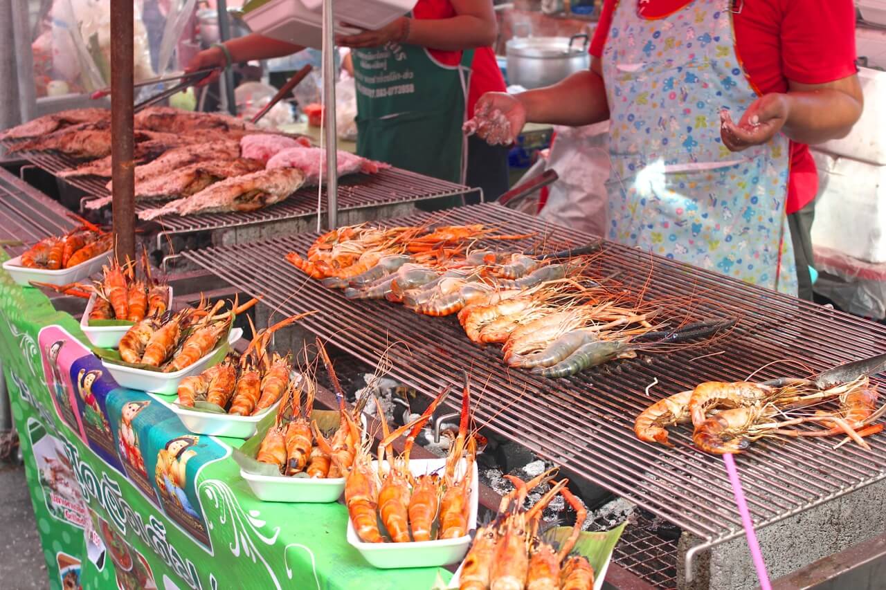 Grilled seafood being prepared at Taling Chan Floating Market.