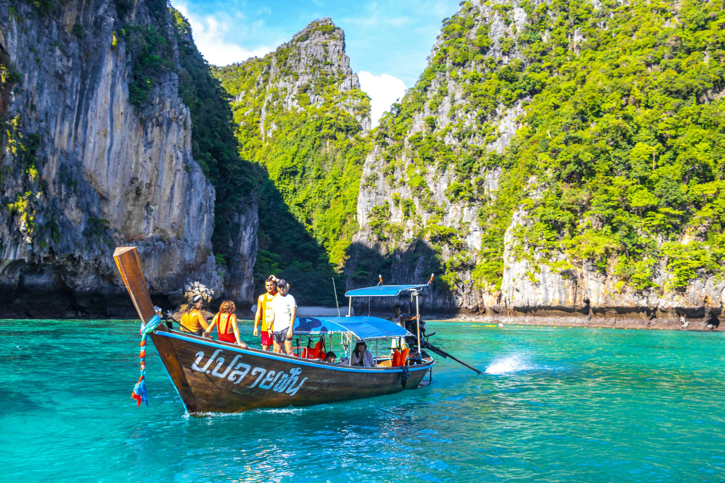 Longtail boats floating in the clear blue water of Ton Sai Bay, Ko Phi Phi Don.