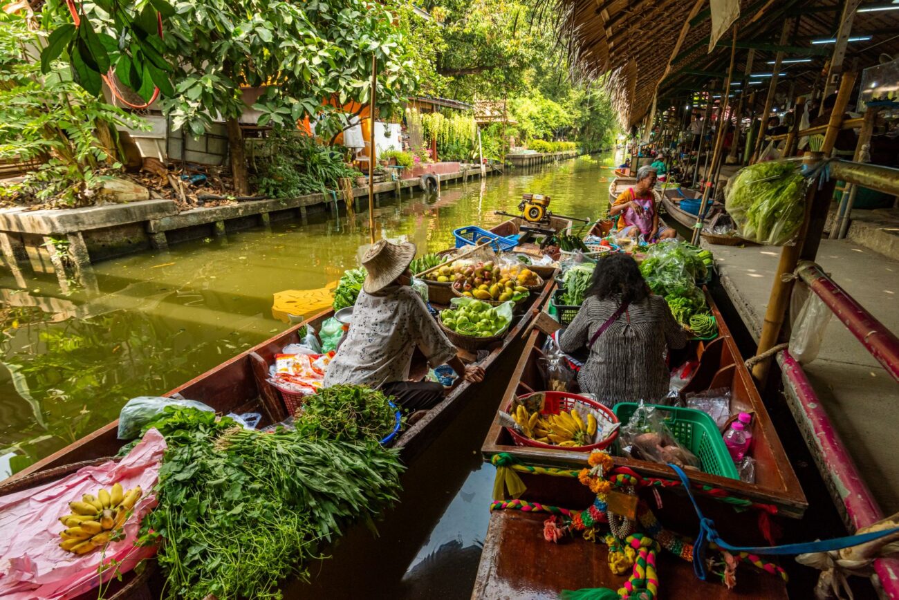 A serene scene at Khlong Lat Mayom Floating Market with food boats.