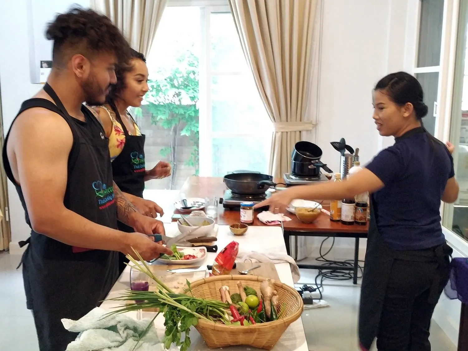 A person learning to cook authentic Thai food in a class.