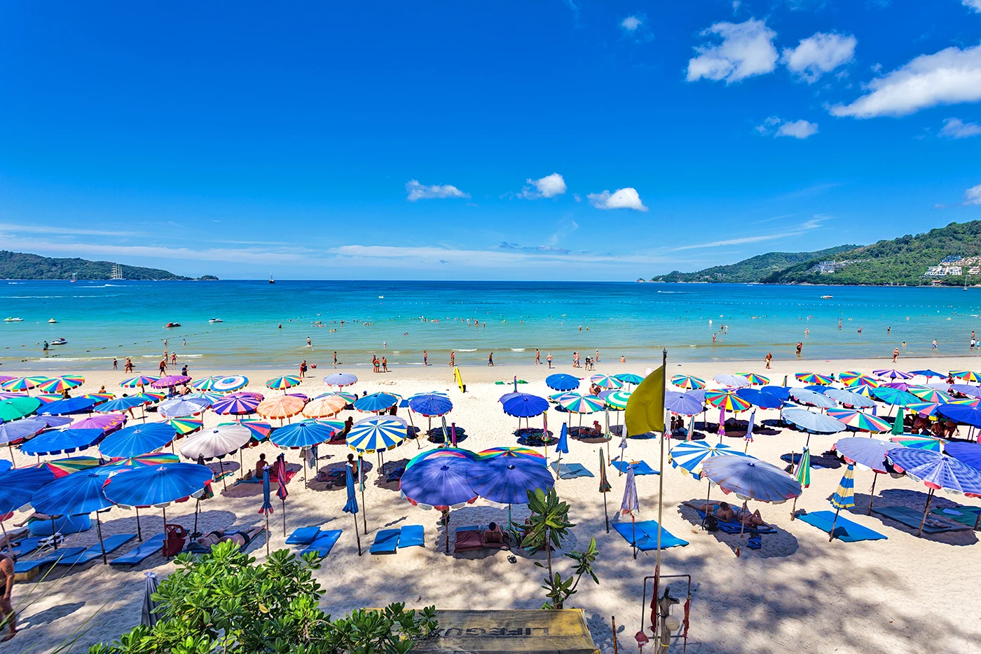 The vibrant and lively Patong Beach at night, with lights from bars and restaurants.