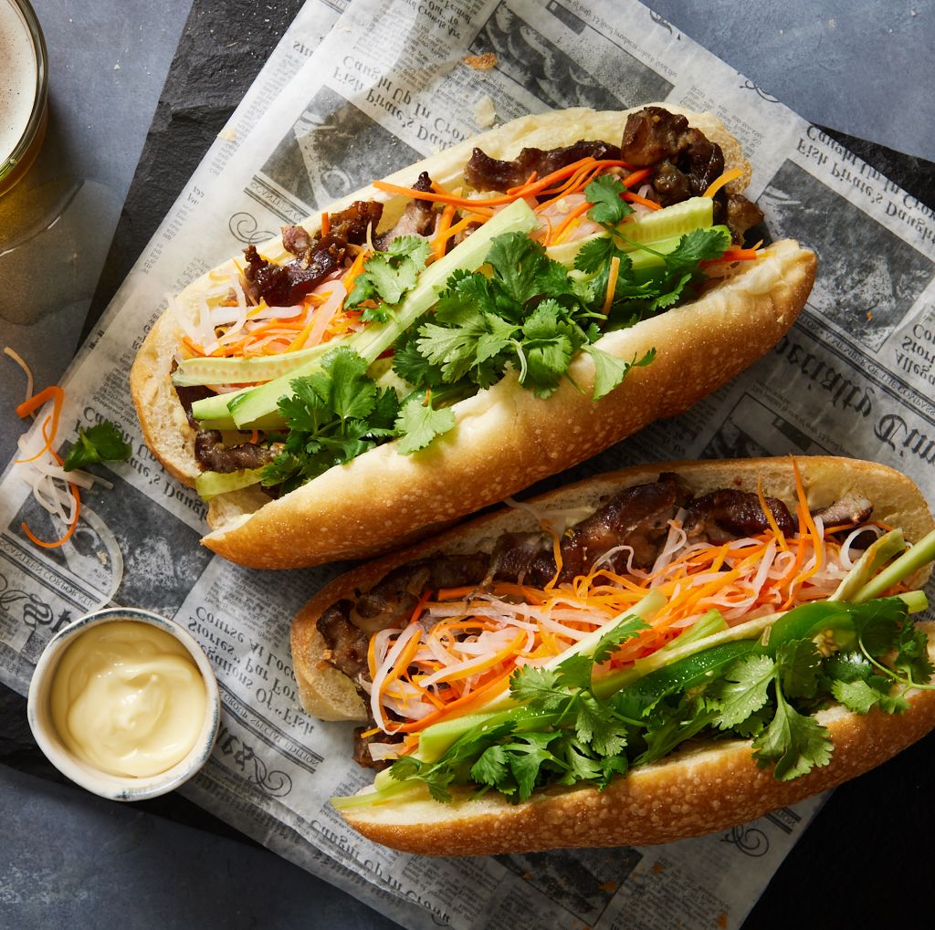 A close-up of a perfectly constructed Vietnamese Banh Mi sandwich from a famous street food stall in Hoi An.